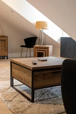 a living room with a coffee table on a rug at Ty Belgrave - Apartment 4 in Aberystwyth