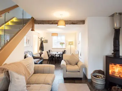 a living room with a couch and a fireplace at Top House in Forden
