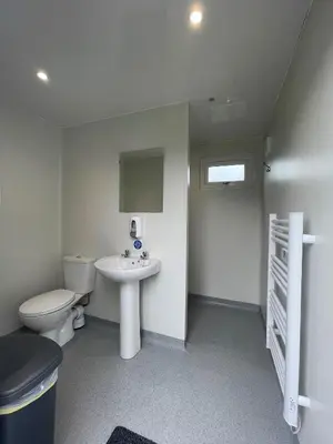 a small bathroom with a toilet and a sink at Eastridge Glamping - Camping Pods in Shrewsbury