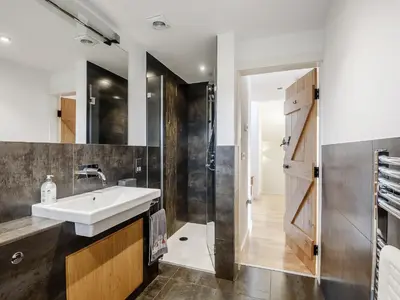 a bathroom with a sink and a shower at Hafan Yr Haul in Arthog