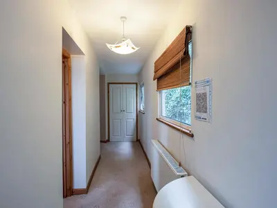 a hallway with a window and a staircase in a house at Brig-Y-Don in Aberaeron