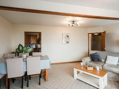 a living room with a couch and a table at Brig-Y-Don in Aberaeron