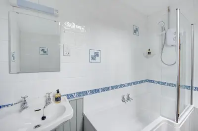 a white bathroom with a tub and a sink at 2 Bed in Dinas Mawddwy oc-bow268 in Machynlleth