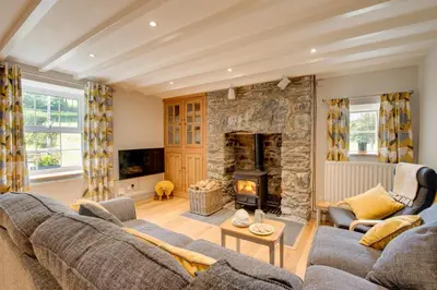 a living room with a couch and a stone fireplace at 2 Bed in Dinas Mawddwy oc-bow268 in Machynlleth