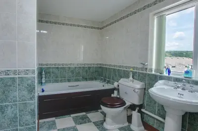 a bathroom with a tub and a toilet and a sink at 4 Bed in Cray oc-bow288 in Cray