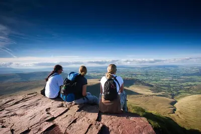three people sitting on the edge of a mountain at 4 Bed in Cray oc-bow288 in Cray