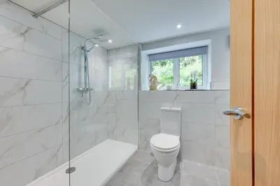 a white bathroom with a toilet and a shower at 3 Bed in Aberystwyth oc-bow297 in Pentre-briwnant
