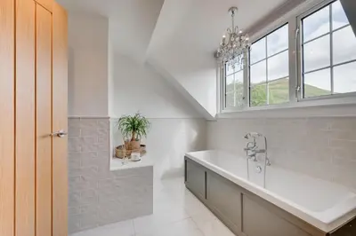 a bathroom with a large sink and a window at 3 Bed in Aberystwyth oc-bow297 in Pentre-briwnant