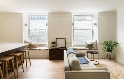 a living room with a couch and a bar at Deluxe Apartment in Historic Quarter near Beaches in Aberystwyth