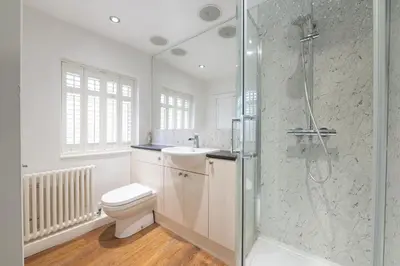 a bathroom with a shower and a toilet and a sink at Besford Square, Shrewsbury Town in Shrewsbury