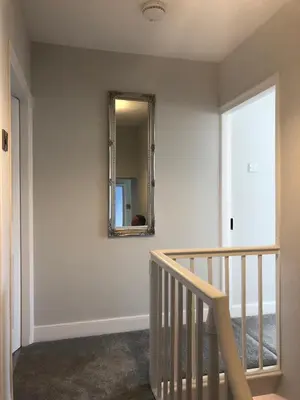 a mirror on a wall next to a stairway at Pengarreg Fawr in Aberystwyth