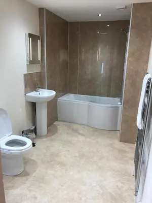 a bathroom with a toilet and a tub and a sink at Pengarreg Fawr in Aberystwyth