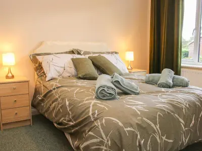 a bed with pillows on it in a bedroom at Greenacres in Kimbolton