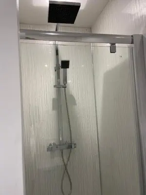 a shower with a shower head in a bathroom at 4 bedroom bungalow in peaceful countryside with log burner - Talar Deg, Capel Madog in Capel Madog