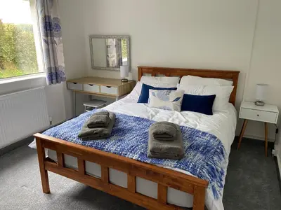 a bedroom with a bed with towels on it at 4 bedroom bungalow in peaceful countryside with log burner - Talar Deg, Capel Madog in Capel Madog