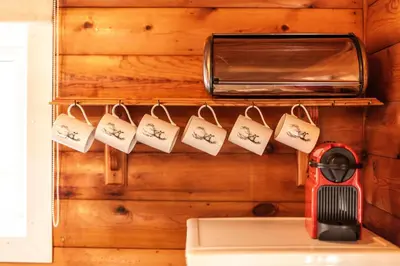 a kitchen with a wall with a toaster and magnets at 3 Bedroom Log Cabin in Snowdonia nr MTB trails in Tanygrisiau