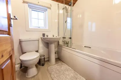 a bathroom with a toilet and a sink and a tub at 3 Bedroom Log Cabin in Snowdonia nr MTB trails in Tanygrisiau