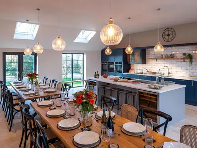 a dining room with wooden tables and chairs at Bennar Fawr in Dyffryn