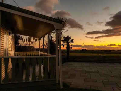 a house with a sunset in the background at Bennar Fawr in Dyffryn