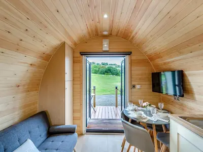 a living room with a table in a tiny house at Elm-Uk36259 in Llanfair Caereinion