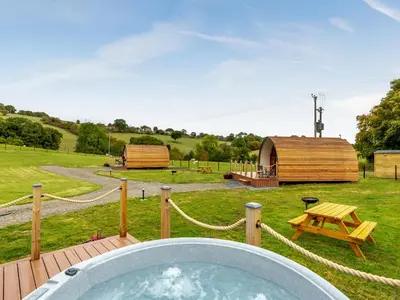 a hot tub in the middle of a yard with a tent at Elm-Uk36259 in Llanfair Caereinion