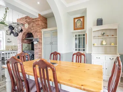 a kitchen and dining room with a wooden table and chairs at Edderton Hall Country House in Welshpool