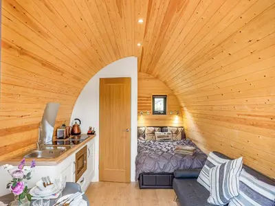 a room with a bed in a wooden room at Oak-Uk36258 in Llanfair Caereinion