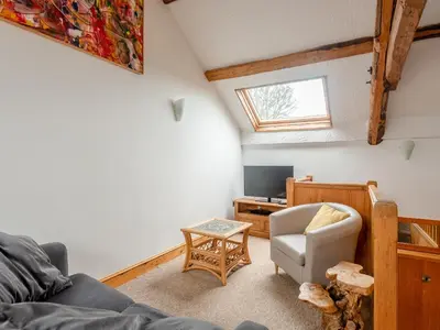 a living room with a couch and a chair at Robins Nest - Uk36208 in Llanfihangel-y-creuddyn