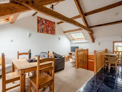 a living room with a table and a couch at Robins Nest - Uk36208 in Llanfihangel-y-creuddyn