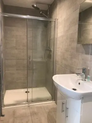 a bathroom with a shower and a sink at Haul y Bore in Aberystwyth