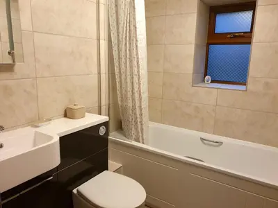 a bathroom with a toilet and a sink and a tub at Ty Barcud in Lampeter