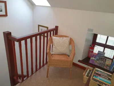 a chair with a pillow sitting on a staircase at Ty Twt in Lampeter