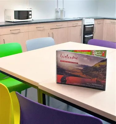a book sitting on top of a table in a kitchen at Aberystwyth University Bunkhouse in Aberystwyth