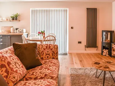 a living room with a couch and a table at Afonig Loyw in Dyffryn