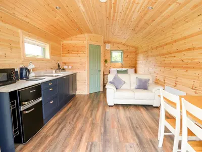 a kitchen and living room in a log cabin at Hwyl in Llandrindod Wells