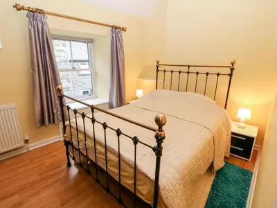 a bedroom with a bed and a window at Gerlan in Harlech