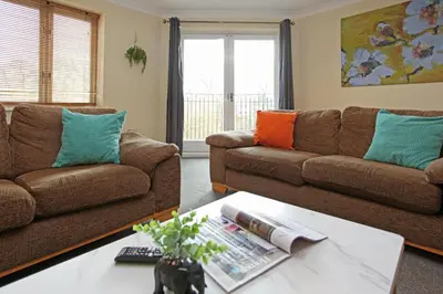 a living room with two couches and a coffee table at St Julians Place in Shrewsbury