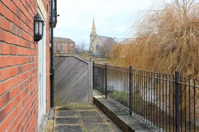 an entrance to a brick building with a wooden gate at St Julians Place in Shrewsbury