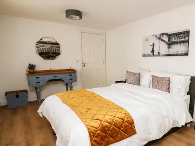 a bedroom with a bed and a desk at Bridgend Cottages in Llandrindod Wells