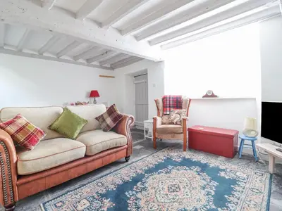 a living room with a couch and two chairs at 1 Hendom in Corwen
