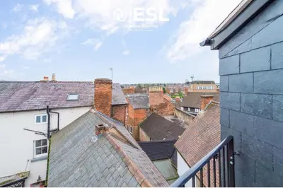 a view of roofs of buildings in a city at Studio 3, Top Floor Town Centre Apartment in Shrewsbury