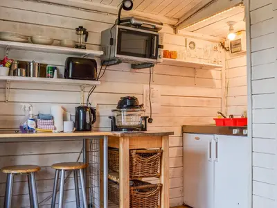 a kitchen with a counter and stools in a trailer at Ty Bach Twt - Uk36419 in Talybont