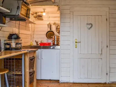 a kitchen with a white door and a sink at Ty Bach Twt - Uk36419 in Talybont