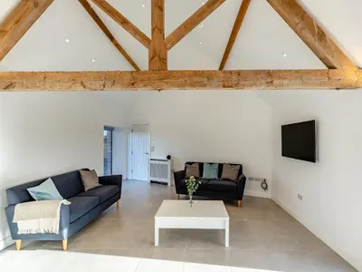 a living room with two couches and a tv at Buckley Farm, Barn 1 - Uk36588 in Oswestry