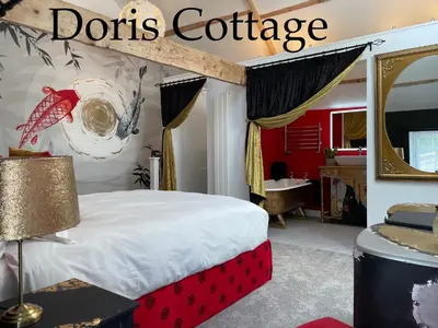 a bedroom with a red and white bed and a mirror at The Good Life Wales with Hot tubs in Llywel