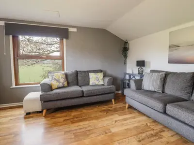 a living room with two couches and a window at Pengeulan in Machynlleth