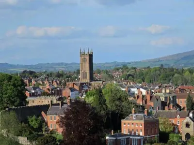 a city with a clock tower in a town at 2 Bedroom Home Near the Heart of Ludlow - Pass the Keys in Ludlow