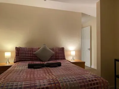 a bedroom with a bed with two lamps on both sides at Apartment - Sleeps 2 - Pet friendly - Parking in Ludlow