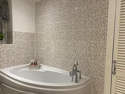 a bath tub in a bathroom with a tiled wall at Apartment - Sleeps 2 - Pet friendly - Parking in Ludlow