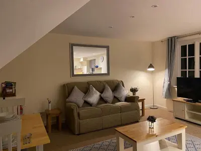 a living room with a couch and a mirror at Apartment - Sleeps 2 - Pet friendly - Parking in Ludlow